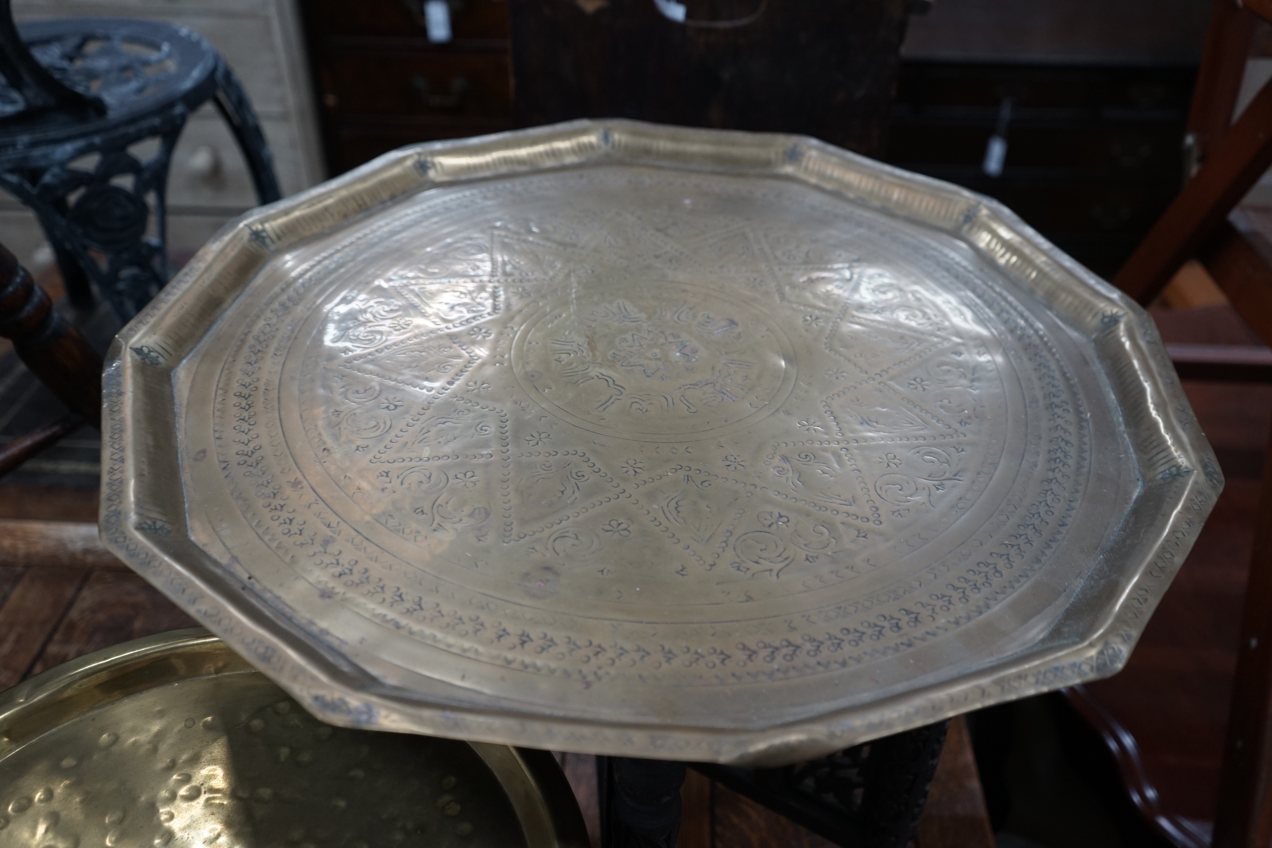 Two Indian brass tray top folding tables, largest width 56cm height 49cm